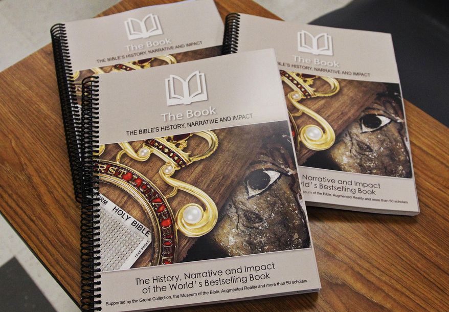 This Friday, April 18, 2014 photo shows a textbook by the Museum of the Bible which will be used for a new elective course starting in Fall 2014 at the suburban Oklahoma City Mustang School District high school in Mustang, Okla. The curriculum, supported by Hobby Lobby chain president Steve Green and billed as a way to teach archaeology, history and the arts through Bible stories, also tells students God is always there in times of trouble and that sinners must "suffer the consequences" of disobeying. (AP Photo/Sue Ogrocki)
