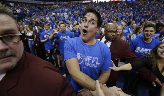 Dallas Mavericks owner Mark Cuban is congratulated after after his team&#x27;s 109-108 win over the San Antonio Spurs in Game 3 in the first round of the NBA basketball playoffs in Dallas, Saturday, April 26, 2014.  The(AP Photo/LM Otero)