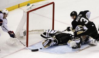 Columbus Blue Jackets&#39; Boone Jenner, left, prepares to put the puck into the net for a goal behind Pittsburgh Penguins goalie Marc-Andre Fleury and Olli Maatta (3) in the first period of Game 5 of a first-round NHL playoff hockey series in Pittsburgh, Saturday, April 26, 2014. (AP Photo/Gene J. Puskar)