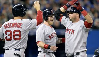 Boston Red Sox&#x27;s A.J. Pierzynski, right, is congratulated by Mike Carp, center, and Grady Sizemore after hitting a grand slam during the third inning of a baseball game against the Toronto Blue Jays in Toronto on Saturday, April 26, 2014. (AP Photo/The Canadian Press, Frank Gunn)