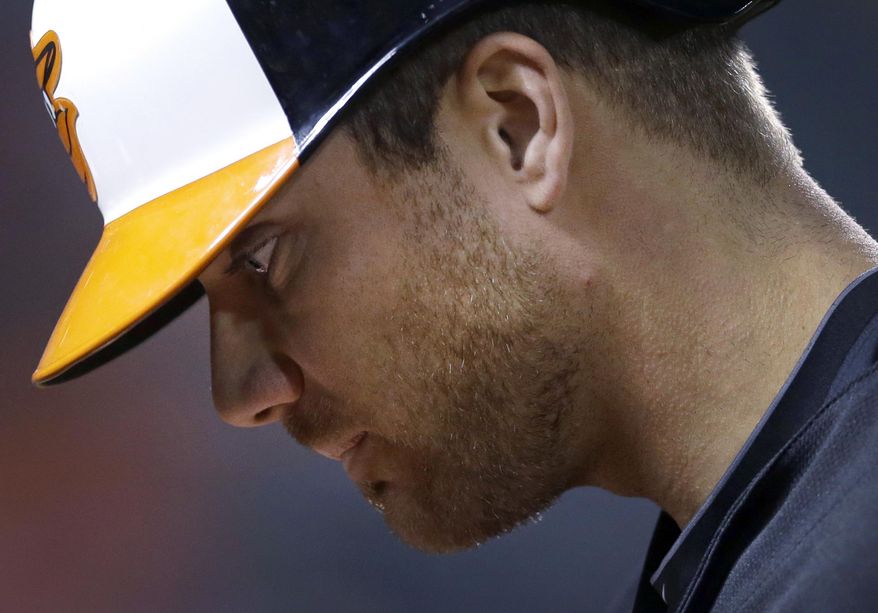 Baltimore Orioles' Chris Davis walks off the field after flying out in the third inning of a baseball game against the Kansas City Royals, Friday, April 25, 2014, in Baltimore. Davis left the game and was diagnosed with a left oblique strain. (AP Photo/Patrick Semansky)