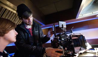 ADVANCE FOR SUNDAY APRIL 27 AND THEREAFTER - Tyler Penrod works on the camera while filming &amp;quot;Altar Ego&amp;quot; as the second assistant camera operator with the Liberty University Cinematic Arts program on Friday April 18, 2014 in Lynchburg, Va.  The religious film features Victoria Jackson and Robert Amaya. (AP Photo/The News &amp;amp; Advance, Jill Nance)
