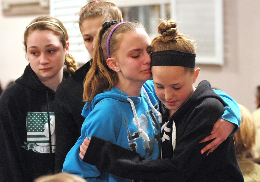 (Peter Casolino-New Haven Register) Friends and family including many students from Jonathan Law High School attend a memorial service at the First United Church of Christ in Milford, Conn., for Maren Sanchez who was killed at the school Friday April 25, 2014. The 16-year-old girl was stabbed to death inside a Connecticut high school Friday, and police were investigating whether a boy attacked her after she turned down an invitation to be his prom date. (AP Photo/The New Haven Register, Peter Casolino)