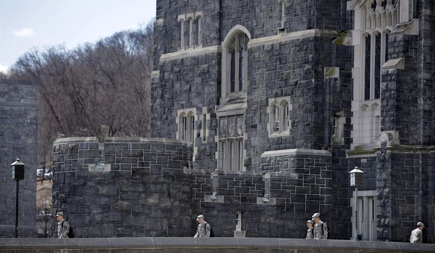 In this April 9, 2014 photo, West Point cadets walk on campus during lunchtime break at the United States Military Academy in West Point, N.Y. With the Pentagon lifting restrictions for women in combat jobs, Lt. Gen. Robert Caslen Jr. has set a goal of boosting the number of women above 20 percent for the new class reporting this summer. (AP Photo/Mel Evans)