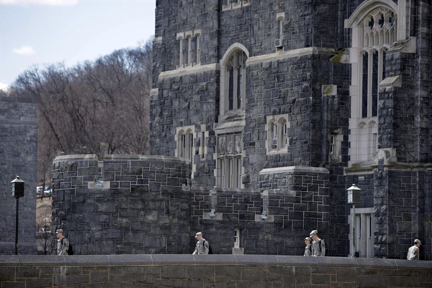 In this April 9, 2014 photo, West Point cadets walk on campus during lunchtime break at the United States Military Academy in West Point, N.Y. With the Pentagon lifting restrictions for women in combat jobs, Lt. Gen. Robert Caslen Jr. has set a goal of boosting the number of women above 20 percent for the new class reporting this summer. (AP Photo/Mel Evans)