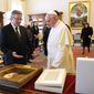 Polish President Bronislaw Komorowski, left, and Pope Francis exchange gifts on the occasion of their private audience at the Vatican, Saturday, April 26, 2014. Komorowski is in Rome to attend Sunday&#39;s canonization ceremony for John Paul II and John XXIII where Pope Francis will elevate the two popes to sainthood.(AP Photo/Vincenzo Pinto, Pool)