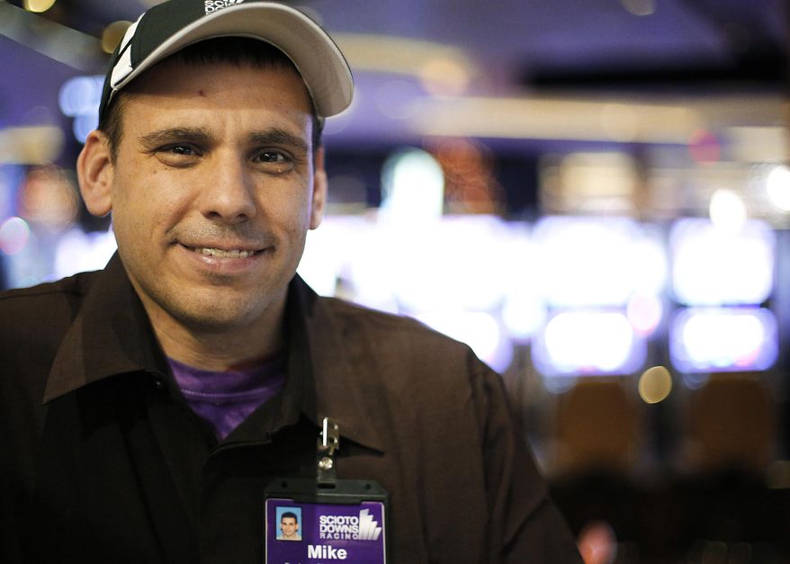 Mike Groleau, 39, poses for a photograph inside the Scioto Downs Racino in Columbus, Ohio on April 9, 2014. Groleau has been working at Scioto Downs in his first real community job outside of workshops for the developmentally disabled. He says he loves the work and gets to split his time helping out at the Dash Cafe and inside the racino's employee dining facility. . (AP Photo / Eamon Queeney, The Columbus Dispatch)