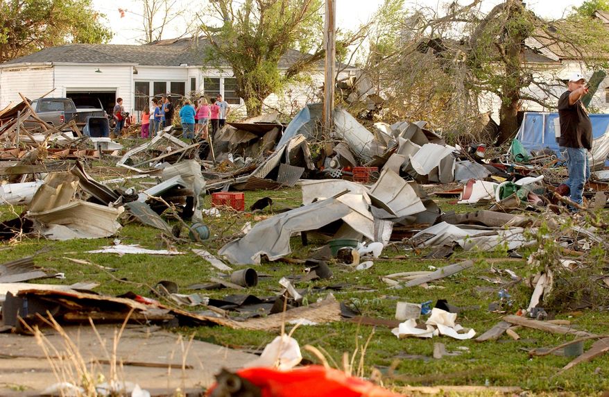 Quapaw, Okla., residents survey the damage in a residential neighborhood struck by a tornado on Sunday evening, April 27, 2014. A powerful storm system rumbled through the central and southern United States on Sunday, spawning a massive tornado that carved path of destruction through the northern Little Rock suburbs and another twister that killed two people in Oklahoma and injured others in Kansas. (AP Photo/Tulsa World, Gary Crow) KOTV OUT; KJRH OUT; KTUL OUT; KOKI OUT; KQCW OUT; KDOR OUT; TULSA OUT; TULSA ONLINE OUT Gary Crow / For the Tulsa World