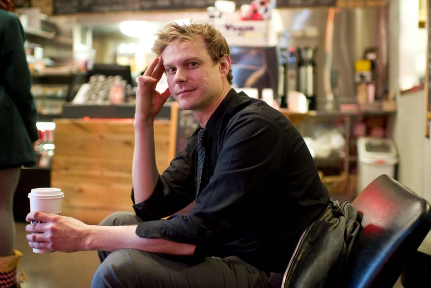 Relief: Nicholas Rastenis takes a brief break from work at a coffee shop in 2012. Since then, he has been handed a big break: a full-time job in his chosen field. (Brian Kersey/Special to the Washington Times)