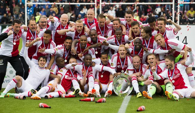 Ajax soccer players celebrate with the trophy after defeating Heracles Almelo in the Dutch Premier League final with a 1-0 score in Almelo, Netherlands, Sunday April 27, 2014. (AP Photo/Vincent Jannink)