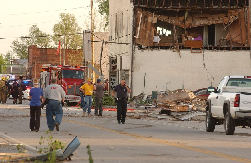 First responders, volunteers and firemen gather on Main Street in Quapaw, Okla. after a tornado struck the city on Sunday evening, April 27, 2014. A powerful storm system rumbled through the central and southern United States on Sunday, spawning a massive tornado that carved path of destruction through the northern Little Rock suburbs and another twister that killed two people in Oklahoma and injured others in Kansas. (AP Photo/Tulsa World, Gary Crow) KOTV OUT; KJRH OUT; KTUL OUT; KOKI OUT; KQCW OUT; KDOR OUT; TULSA OUT; TULSA ONLINE OUT