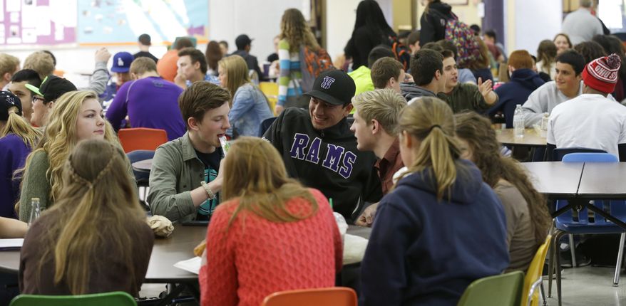 In this April 18, 2014 photo, students at North Thurston High School in Olympia, Wash. fill nearly every available seat during a lunch period, which has 700 students scheduled but only seating for 240. An Associated Press analysis of Washington school enrollment data shows 136 school districts, out of 295, added students between the 2011-12 school year and the current academic year. (AP Photo/Ted S. Warren)