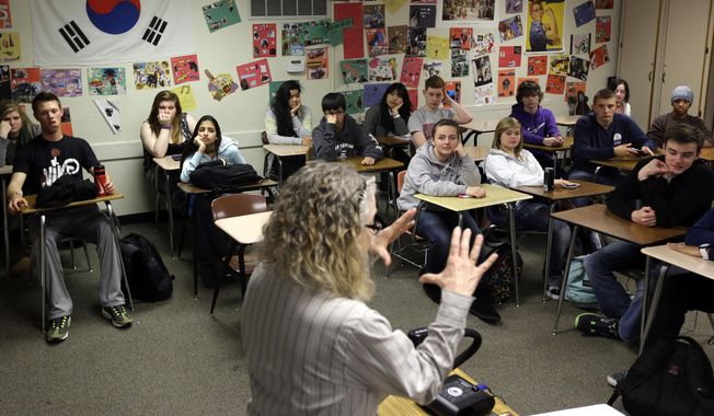 In this April 18, 2014 file photo, students crowd into a classroom at North Thurston High School in Olympia, Wash. (AP Photo/Ted S. Warren) **FILE**