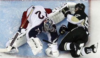 Pittsburgh Penguins&#39; Marcel Goc (57) collides with Columbus Blue Jackets goalie Sergei Bobrovsky during the third period of Game 5 of a first-round NHL playoff hockey series in Pittsburgh, Saturday, April 26, 2014. The Penguins won 3-1. (AP Photo/Gene J. Puskar)