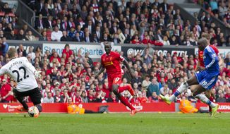 Chelsea&#x27;s Demba Ba, right, scores against Liverpool during their English Premier League soccer match at Anfield Stadium, Liverpool, England, Sunday April 27, 2014. (AP Photo/Jon Super)