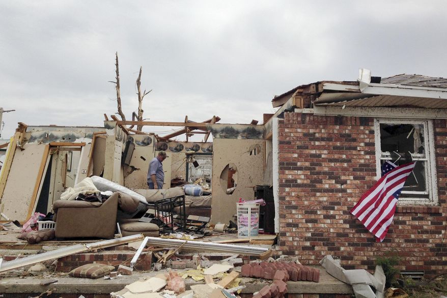 Bob Van Byssum walks through his home in Little Rock, Ark., Monday, April 28, 2014. A tornado struck the central Arkansas town Sunday. (AP Photo/Andrew DeMillo)