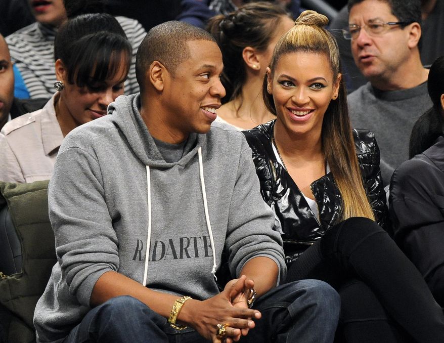 FILE - This Nov. 23, 2012 file photo shows entertainers Jay Z and his wife Beyonce at the Brooklyn Nets against the Los Angeles Clippers NBA basketball game at Barclays Center in New York. The couple will launch the co-headlining "On the Run Tour" on June 25 in Miami. (AP Photo/Kathy Kmonicek, File)