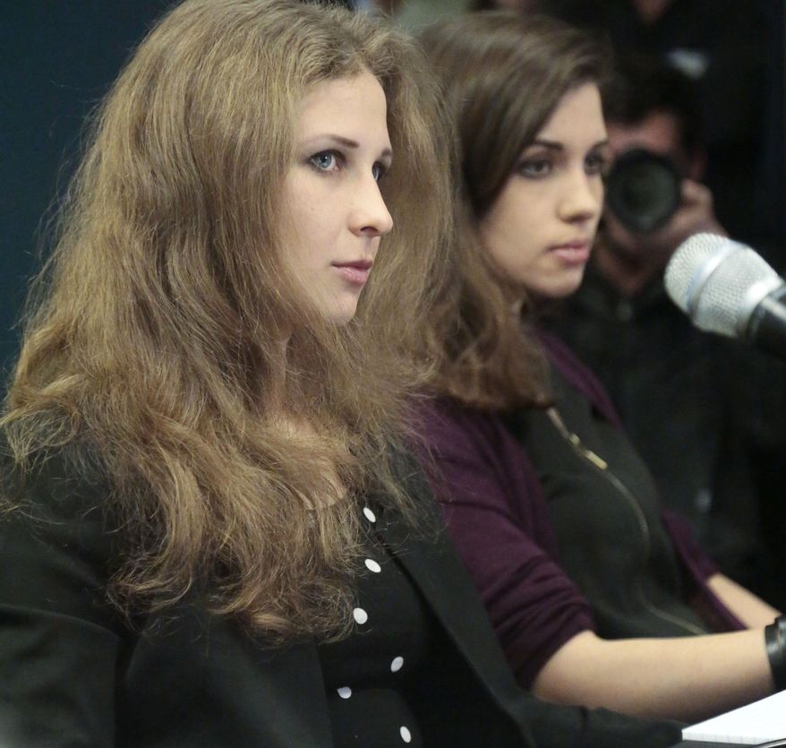 FILE - In a Tuesday Feb. 4, 2014 file photo, Nadezhda “Nadya” Tolokonnikova and Maria “Masha” Alyokhina, of the punk band Pussy Riot, hold a news conference at Amnesty International's New York headquarters. It was announced Monday, April 28, 2014, that Alyokhina and Tolokonnikova are expected at the PEN American Center Literary Gala scheduled for May 5 at the Museum of Natural History in New York. (AP Photo/Bebeto Matthews, File)