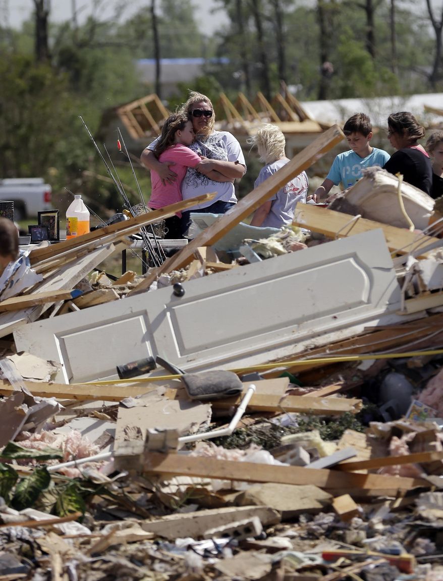Residents and friends sift through debris after a tornado struck the area, Monday, April 28, 2014, in Vilonia, Ark. (AP Photo/Eric Gay)