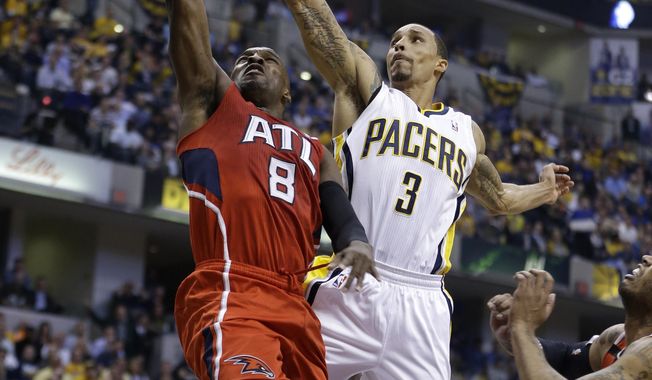 Atlanta Hawks&#x27; Shelvin Mack (8) puts up a shot against Indiana Pacers&#x27; George Hill (3) during the first half in Game 5 of an opening-round NBA basketball playoff series Monday, April 28, 2014, in Indianapolis. (AP Photo/Darron Cummings)