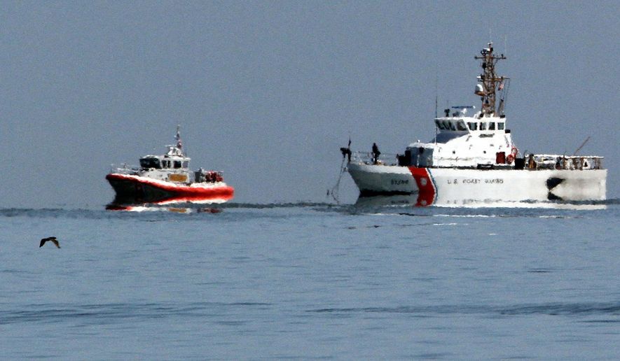 Coast Guard vessels continue to search the waters of San Pablo Bay on Monday, April 28, 2014, in Richmond, Calif. A federal transportation safety official arrived Monday in Northern California to investigate a collision between two small planes that sent one crashing into the San Francisco Bay. The collision occurred Sunday near the Richmond-San Rafael Bridge and involved a single-engine Cessna 210 and a single-engine Hawker Sea Fury TMK 20. (AP Photo/Bay Area News Group, Laura A. Oda)
