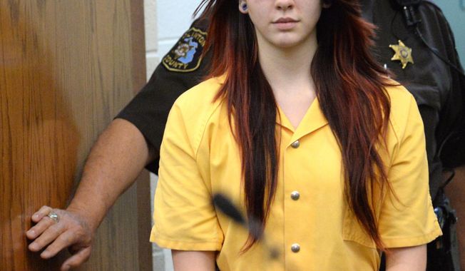 Samantha Grigg enters the Clinton County Circuit Court in St. Johns, Mich., Monday, April 28, 2014, where she pleading guilty to manslaughter in the death of Michigan State University student Dustyn Frolka, saying the victim jumped from a moving SUV to escape being attacked and was left along the side of an interstate. Grigg told the court that she drove Frolka, 19, to ATMs before two others beat and robbed him, the Lansing State Journal and MLive.com reported. Frolka was found unconscious Feb. 15 on Interstate 69 in Clinton County's Bath Township, near Lansing.  (AP Photo/The State Journal, Greg DeRuiter) NO SALES