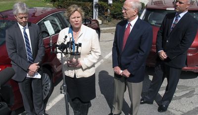 Montpelier Mayor John Hollar, left, U.S. Rep. Peter Welch, second from right, and Dan Keene, right, owner of Lamoille Valley Ford, listen as Karen Glitman, second from left, of the Vermont Energy Investment Corp., speaks about the importance of electric vehicles, Monday, April 28, 2014, in Montpelier, Vt. Welch said he is planning to introduce legislation in Congress to increase the tax credit for the purchase of electric vehicles to up to $10,000 as a way to make it easier for people to buy electric cars. (AP Photo/Wilson Ring)