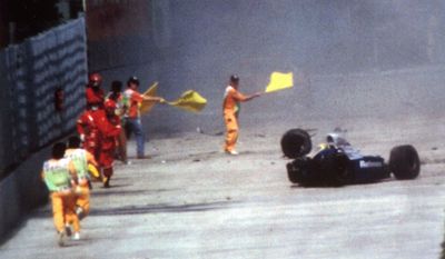 FILE - In this May 1, 1994, file photo, Race officials run toward Brazil&#39;s Aytron Senna after he crashed with his Williams-Renault during the San Marino F-1 Grand Prix in Imola.  Senna died at a Bologna hospital later. Nearly three years after the fatal crash, six top Formula One figures, including Frank Williams, head of the successful Williams-Renault team, face manslaughter carges in a trial starting in Imola Thursday, February 20, 1997. (AP Photo/file)