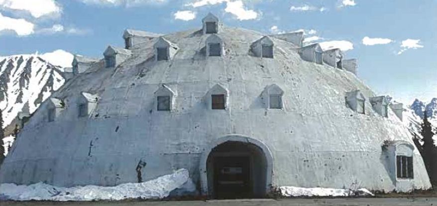 This undated photo provided by Brad Fisher, shows an urethane igloo in Anchorage, Alaska. The igloo, an embodiment of an Alaska cliche, and a must-stop for tourists heading for Denali National Park and Preserve, is for sale. The 80-foot high structure, erected more than four decades and never completed, sits on a 38-acre site, which is part of the sales package. (AP Photo/Brad Fisher)