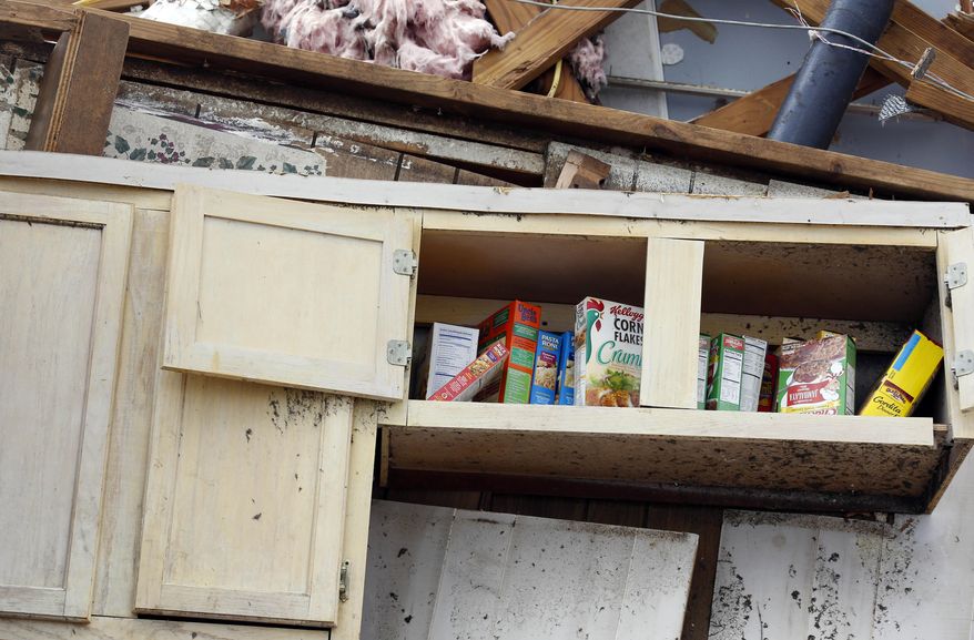 Cooking products are undisturbed in this kitchen shelf in what remains of this south Louisville, Miss., neighborhood, Tuesday, April 29, 2014. Numerous businesses, residences and the community hospital were destroyed or heavily damaged after a tornado hit the east Mississippi community Monday. (AP Photo/Rogelio V. Solis)