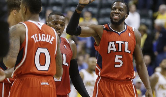Atlanta Hawks&#x27; DeMarre Carroll (5) celebrates with his teammates late in the second half in Game 5 of an opening-round NBA basketball playoff series against the Indiana Pacers Monday, April 28, 2014, in Indianapolis. Atlanta defeated Indiana 107-97. (AP Photo/Darron Cummings)