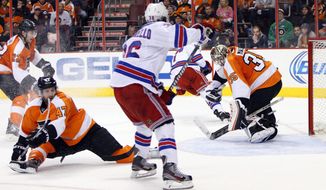 Philadelphia Flyers&#39; Steve Mason, right, makes a glove save during the second period in Game 6 of an NHL hockey first-round playoff series against the New York Rangers, Tuesday, April 29, 2014, in Philadelphia. (AP Photo/Chris Szagola)