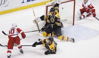 Detroit Red Wings&#39; Henrik Zetterberg (40) scores past Boston Bruins&#39; Tuukka Rask, behind center, during the third period in Game 5 in the first round of the NHL hockey Stanley Cup playoffs in Boston, Saturday, April 26, 2014. Boston won 4-2 and eliminated the Red Wings from the playoffs. (AP Photo/Michael Dwyer)