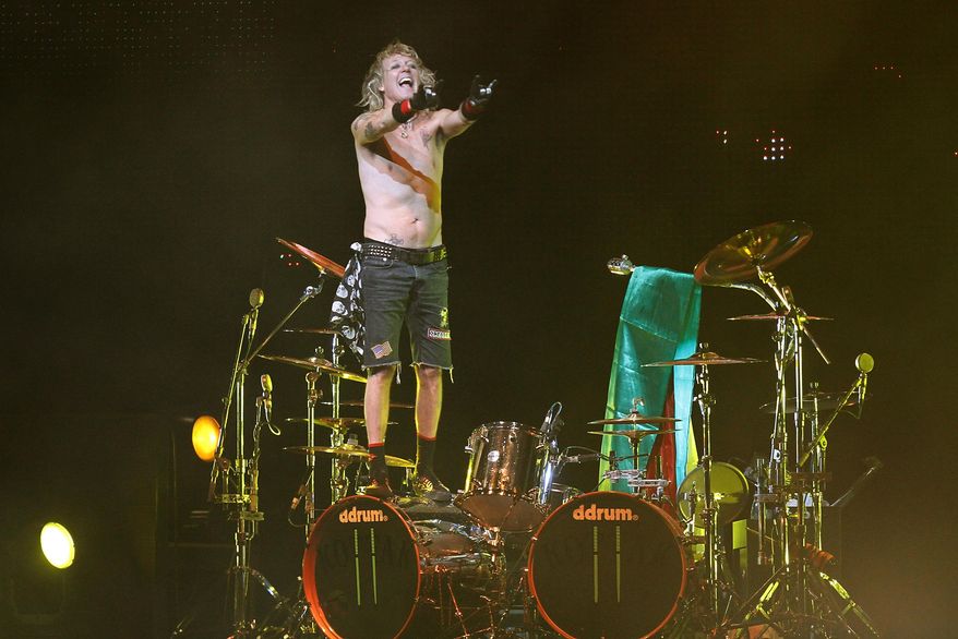 FILE- In this Thursday, Sept. 16, 2010, file photo, James Kottak, drummer of the German rock band Scorpions, gestures during the band's farewell tour in La Paz, Bolivia. Newspapers in the United Arab Emirates are reporting that the American drummer for the rock band Scorpions has been sentenced to one month in jail after being convicted of offensive behavior in Dubai. The government-backed National newspaper reported Tuesday, April 29, 2014, that James Kottak was convicted of insulting Islam, raising his middle finger, and being under the influence of alcohol while in transit at Dubai airport. (AP Photo/Juan Karita, File)