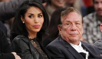 ** FILE ** In this Dec. 19, 2010, file photo, Los Angeles Clippers owner Donald Sterling, right, and V. Stiviano, left, watch the Clippers play the Los Angeles Lakers during an NBA preseason basketball game in Los Angeles. (AP Photo/Danny Moloshok, File)