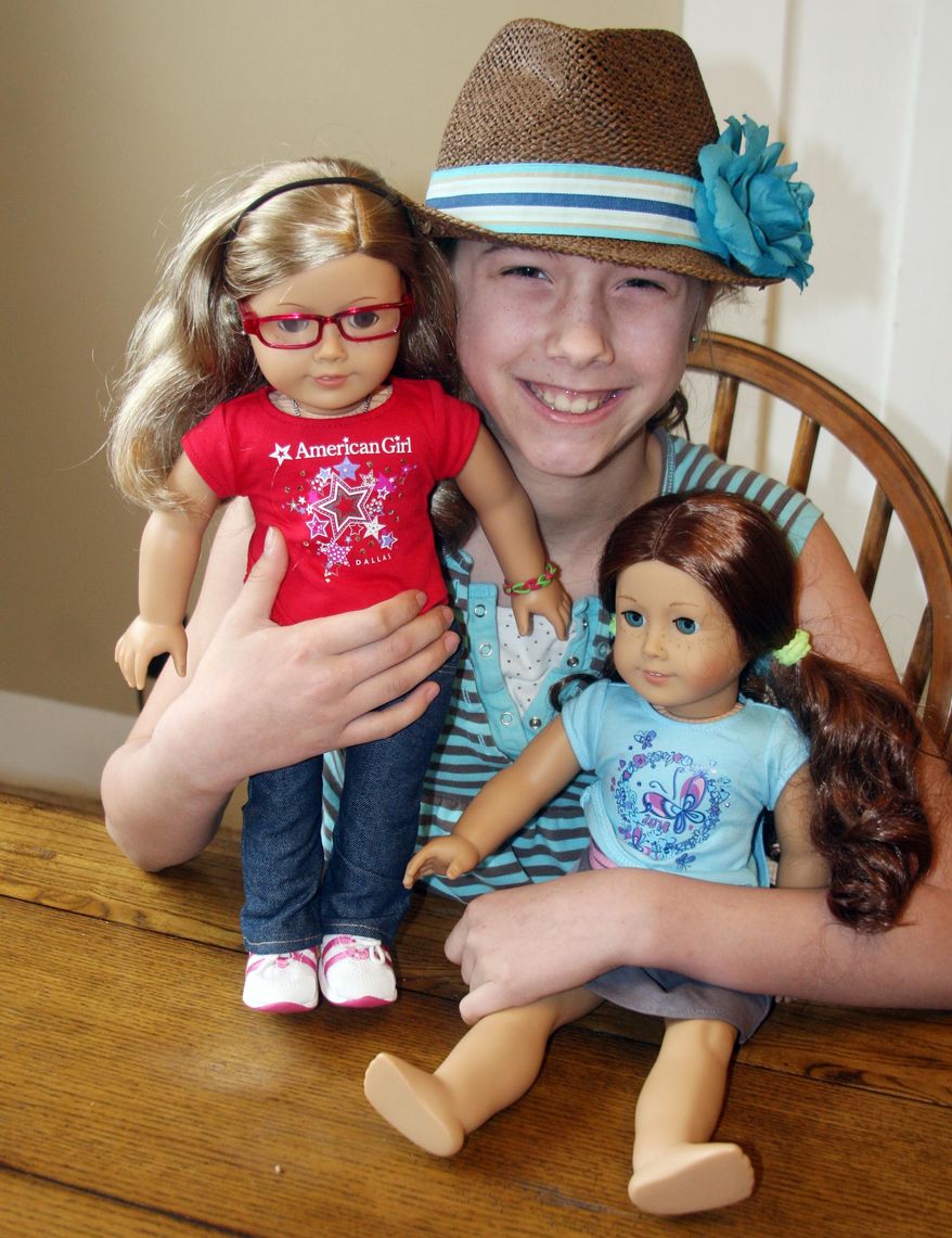 ADVANCED FOR RELEASE MONDAY, MAY 5, 2014 Anja Busse of Antigo cuddles her two American Girl dolls. Busse, who was diagnosed with Type 1 Diabetes in October, has started an online petition drive to persuade the popular toy manufacturer to offer dolls with diabetic supplies. (AP Photo/Antigo Daily Journal, Lisa Haefs)