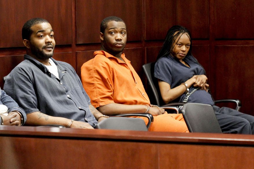 Shundarius Lawson, center, sits in Muskegon County District Judge Michael J. Nolan's courtroom for an arraignment on Wednesday, April 30, 2014 in Muskegon, Mich. Muskegon County Prosecutor D.J. Hilson says Lawson, 20, was in a sport utility vehicle from which shots were fired that killed 17-year-old Marquis Gresham on April 23. According to Hilson, the investigation is continuing, and more charges against others are possible. Gresham was a junior and a starting center on the Muskegon Heights Public School Academy team that advanced to the state semifinals. (AP Photo/The Muskegon Chronicle, Madelyn Hastings) ALL LOCAL TV OUT; LOCAL TV INTERNET OUT