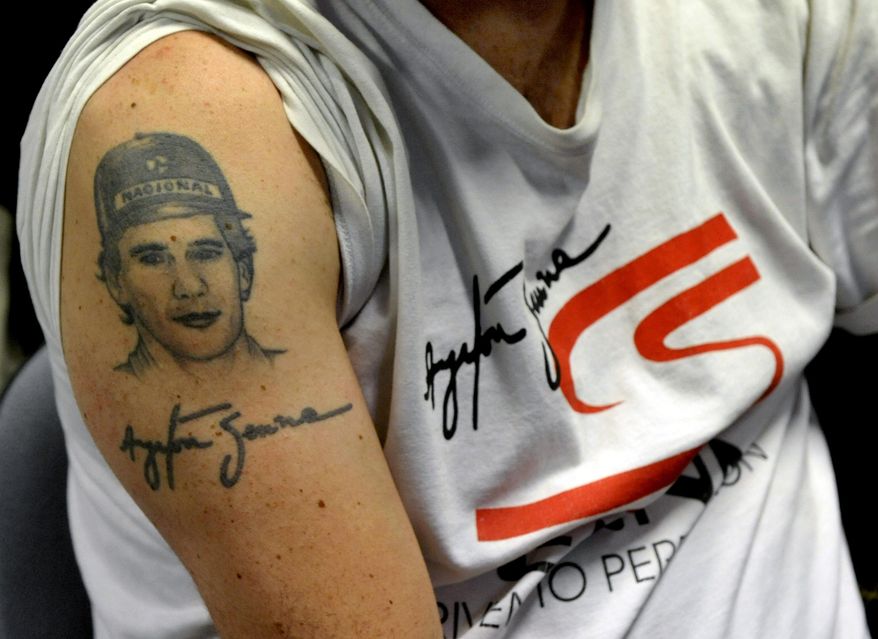 A man sports a tattoo depicting late Brazilian F1 driver Ayrton Senna, in Imola, Italy, Wednesday, April 30, 2014. It is a testament to Ayrton Senna's lasting impact on Formula One that the 20th anniversary of his death will be observed this week with five days of commemorations at the Imola track where he had his fatal accident. Current and past F1 drivers, mechanics, racing officials and fans will pay their respects to Senna and Austrian driver Roland Ratzenberger, who also died at the 1994 San Marino Grand Prix. (AP Photo/Marco Vasini)
