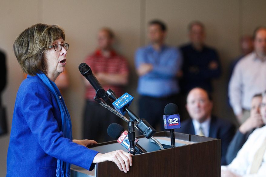 Ginger Woolley, of the Rock Canyon Preservation Alliance, speaks during a news conference at the Zions Bank building in Provo on Tuesday, April 29, 2014. Mayor Curtis announced that the city will be purchasing 80 acres of land in Rock Canyon, ending a multi-decade land dispute and ensuring the preservation of the canyon. (AP Photo/The Daily Herald, Spenser Heaps)