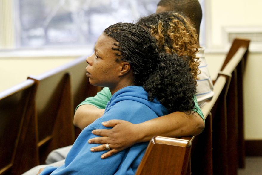 Family members sit in Muskegon County District Judge Michael J. Nolan's courtroom for the arraignment of Shundarius Lawson on Wednesday, April 30, 2014 in Muskegon, Mich. Muskegon County Prosecutor D.J. Hilson says Lawson, 20, was in a sport utility vehicle from which shots were fired that killed 17-year-old Marquis Gresham on April 23. According to Hilson, the investigation is continuing, and more charges against others are possible. Gresham was a junior and a starting center on the Muskegon Heights Public School Academy team that advanced to the state semifinals. (AP Photo/The Muskegon Chronicle, Madelyn Hastings) ALL LOCAL TV OUT; LOCAL TV INTERNET OUT