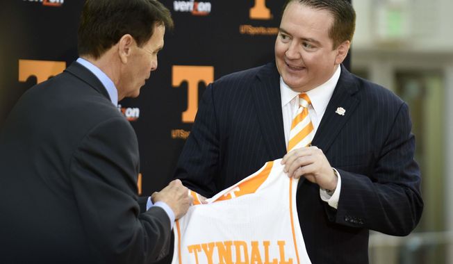 FILE - In this April 22, 2014, file photo, Donnie Tyndall, right, is introduced as Tennessee men&#x27;s basketball coach by athletic director Dave Hart during a news conference in Knoxville, Tenn. Hart says he sees plenty of similarities between Tyndall and Volunteers football coach Butch Jones.  (AP Photo/Knoxville News Sentinel, Amy Smotherman Burgess, File)