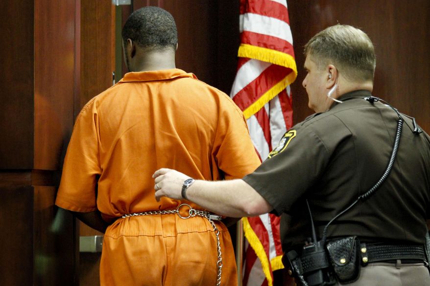 Shundarius Lawson is escorted out of Muskegon County District Judge Michael J. Nolan's courtroom after his arraignment on Wednesday, April 30, 2014 in Muskegon, Mich. Muskegon County Prosecutor D.J. Hilson says Lawson, 20, was in a sport utility vehicle from which shots were fired that killed 17-year-old Marquis Gresham on April 23. According to Hilson, the investigation is continuing, and more charges against others are possible. Gresham was a junior and a starting center on the Muskegon Heights Public School Academy team that advanced to the state semifinals. (AP Photo/The Muskegon Chronicle, Madelyn Hastings) ALL LOCAL TV OUT; LOCAL TV INTERNET OUT