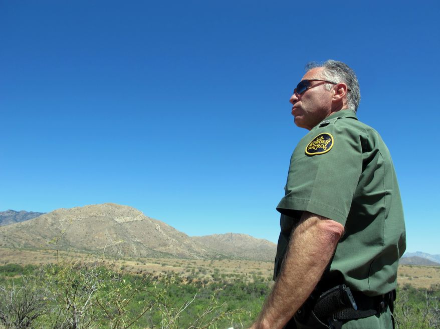 U.S. Border Patrol Tucson Sector Chief Manuel Padilla looks out over the desert terrain in the Buenos Aires National Wildlife Refuge, Wednesday, April 30, 2014, near Sasabe, Ariz. Padilla and other Border Patrol officials spent the day discussing the dangers for people trying to cross the border illegally from Mexico into the U.S., after they enter the remote desert terrain. (AP photo/Brian Skoloff)