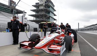 Former Indy 500 champion Juan Pablo Montoya, of Colombia, sits in his car during testing for the inaugural Grand Prix of Indianapolis auto race on the new road course at Indianapolis Motor Speedway in Indianapolis, Wednesday, April 30, 2014. (AP Photo/Michael Conroy)