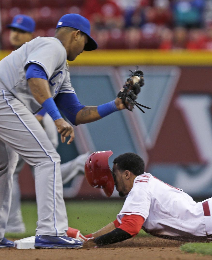 Cincinnati Reds&#39; Billy Hamilton, right, steals second base ahead of the tag by Chicago Cubs shortstop Starlin Castro in the first inning of a baseball game, Tuesday, April 29, 2014, in Cincinnati. (AP Photo)