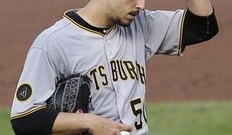 Pittsburgh Pirates starting pitcher Charlie Morton adjusts his cap before an at-bat against Baltimore Orioles&#39; Steve Pearce in the sixth inning in the first baseball game of a doubleheader on Thursday, May 1, 2014, in Baltimore. Pearce drove in a run during his at-bat and Morton was relieved. (AP Photo/Patrick Semansky)