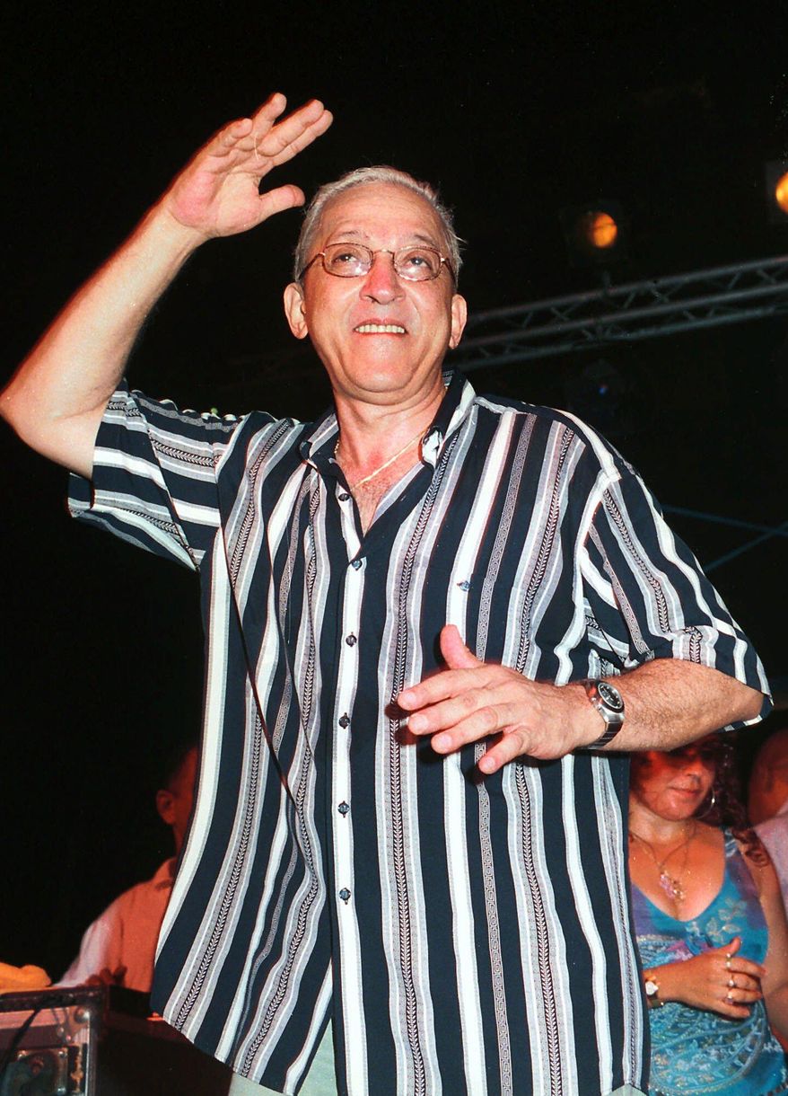 FILE - In this Aug. 26, 2001 file photo, Juan Formell, leader of the Cuban orchestra Los Van Van, performs late Sunday in Havana, Cuba during a farewell summer concert. The noted Cuban musican, who for more than four decades was the driving force behind the big band salsa orchestra Los Van Van, has died. He was 71 years old. Formell's death was announced Thursday, May 1, 2014, on Cuban state television. (AP Photo/Ernesto Mastrascusa, File)