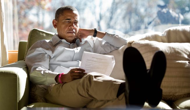President Obama reads briefing material while meeting with advisers inside his cabin at Camp David in 2012. Compared with President Bush, seen right with first lady Laura Bush on a 4-mile walk, Mr. Obama seldom uses the presidential retreat. On weekends, he often opts to play golf. The Bushes founds the grounds to be a good place for family. (WHITE HOUSE PHOTOGRAPHS)