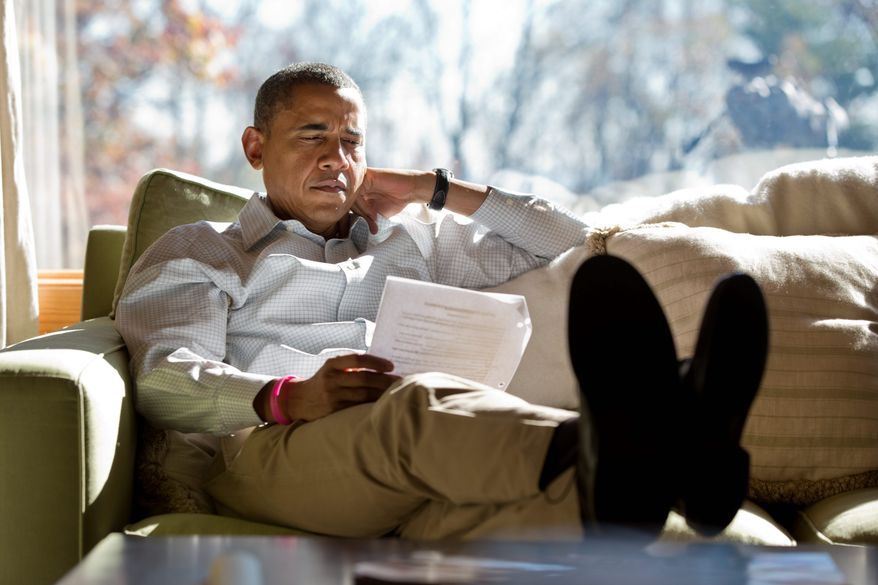 President Obama reads briefing material while meeting with advisers inside his cabin at Camp David in 2012. Compared with President Bush, seen right with first lady Laura Bush on a 4-mile walk, Mr. Obama seldom uses the presidential retreat. On weekends, he often opts to play golf. The Bushes founds the grounds to be a good place for family. (WHITE HOUSE PHOTOGRAPHS)