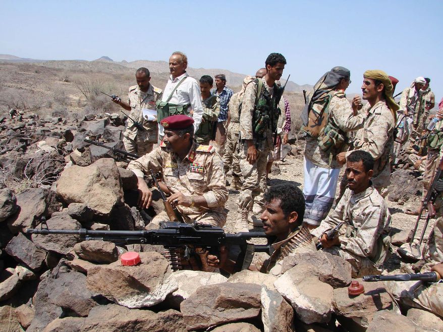 In this handout photo provided by Yemen&#39;s Defense Ministry, Yemeni troops take position during the fight against al-Qaida militants in the southern province of Shabwa, Yemen, Wednesday, April 30, 2014. Yemeni military on Tuesday, April 29, launched a major offensive targeting al-Qaida hideouts and strongholds, killing at least eight suspected militants, security officials said. (AP Photo/Yemen&#39;s Defense Ministry)